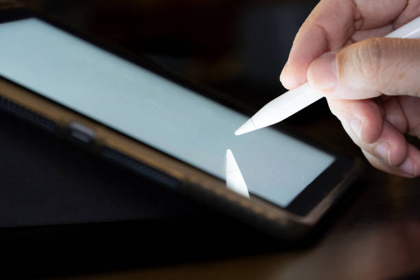 istock Hand use  pen stylus touch and drow on Tablet screen Mock up with light. 1226128939