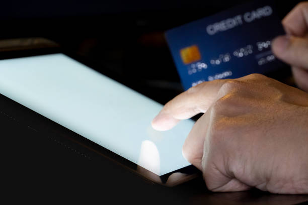 istock Finger touch on Tablet screen Mock up with light the credit card. 1226128980