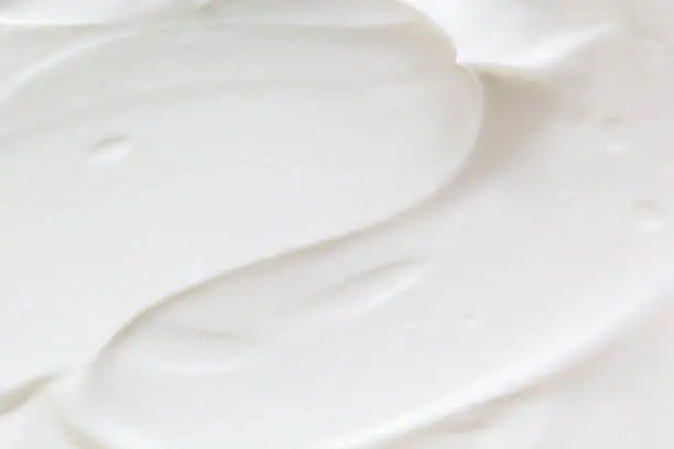 Sour cream, greek yogurt texture. White dairy product sample, creamy mousse closeup. Healthy natural food background