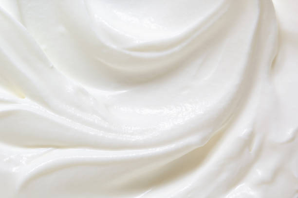 Sour cream, greek yogurt texture Sour cream, greek yogurt texture. White dairy product swirl closeup. Creamy healthy natural food macro photography. Top view greek yogurt photos stock pictures, royalty-free photos & images