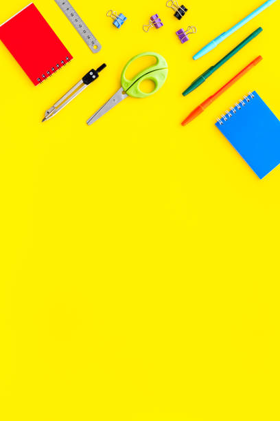 istock School supplies pattern - notebook, pen, ruler, sciccors - on yellow table top-down space for text 1226134779