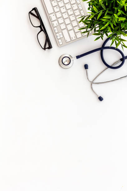 istock Doctor office desk with keyboard. White table top view space for text 1226135584