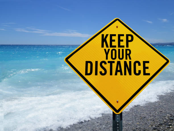 istock Keep your distance sign on beach 1226143706