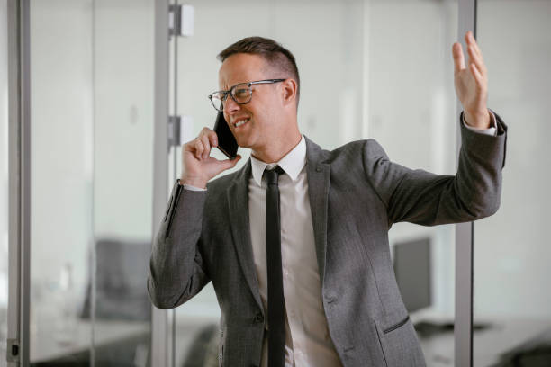istock Handsome businessman talking to the phone in office. 1226146638