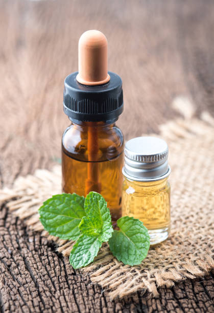 istock fresh mint essential oil on wood background 1226150303