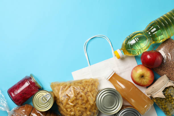 istock Different food on blue background, top view. Donation concept 1226150328