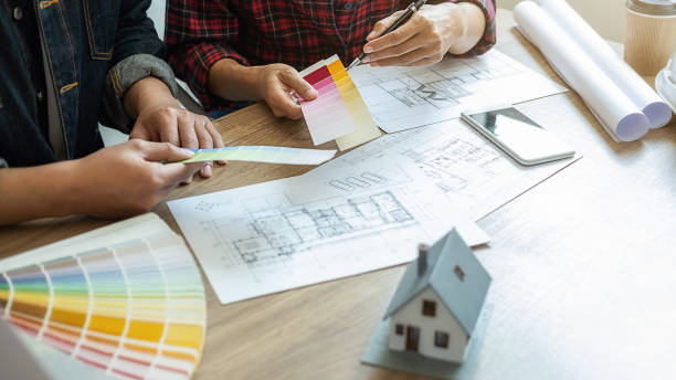istock Interior designer and Architect choosing color in color swatch samples chart for house coloring selection in office with blueprint. Construction concept. 1226151293