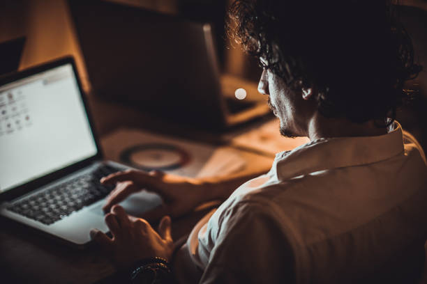 istock Man working late at night in office alone 1226152114