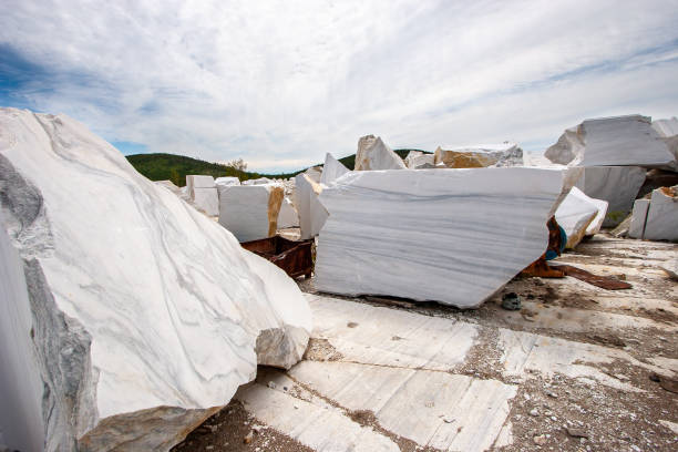 istock Large white marble blocks in an old abandoned quarry. Beautiful marble texture. Smooth cuts at the stones. Cloudy. Horizontal. 1226152262