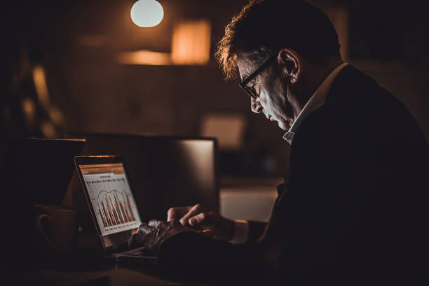 istock Mature man working late at night in office alone 1226152316