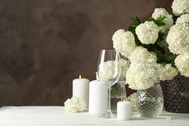 istock Composition with hydrangea flowers and candles against brown background. Romantic evening 1226153221