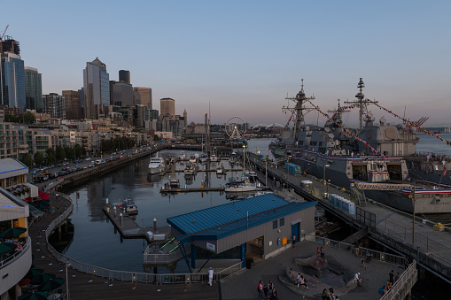 Seattle, USA - July 31, 2019: US Navy ships docked at pier 66 on Elliott bay late in the day during the annual Seafair and fleet week.