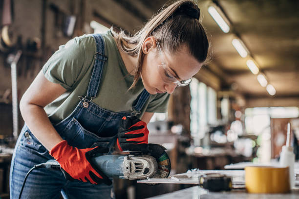istock One young woman working with angle grinder in workshop 1226157165