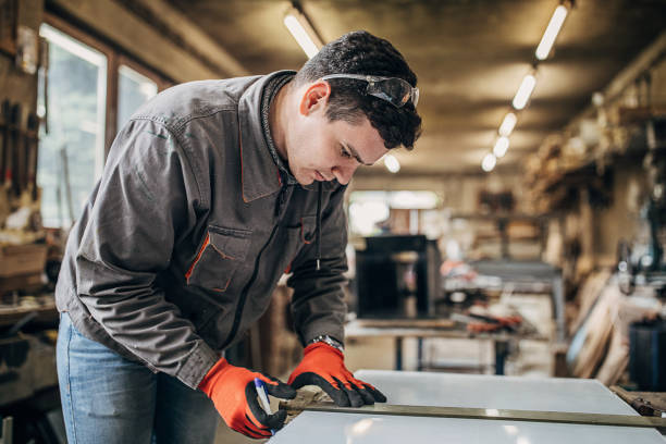 istock Manual worker marking a measurement on a piece of plexiglass 1226158775