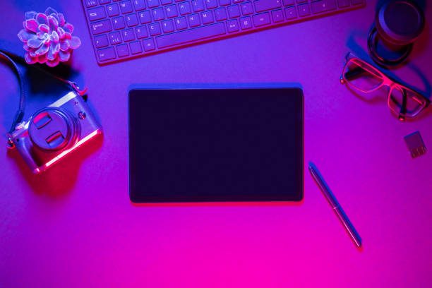 istock Directly above shot of computer keyboard with camera and digital tablet on illuminated table 1226158986