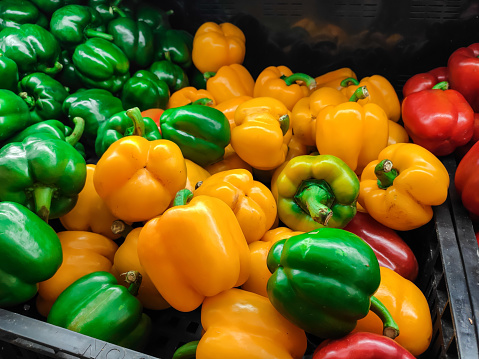 An Asian woman is selecting fresh vegetable in supermarket