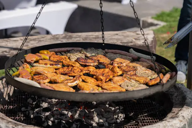 Photo of Grilled meat on a swivel grill