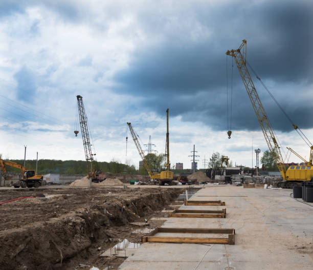 istock Construction site with tower cranes. The pit with mounted tires. Tower cranes and textured sky. 1226164365