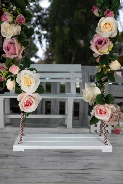 istock Wedding swing decorated with rose flowers hanging 1226166356