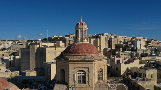 Aerial view of dome of the church against the backdrop of the city, historical architecture. Bormela, Valletta, Malta.