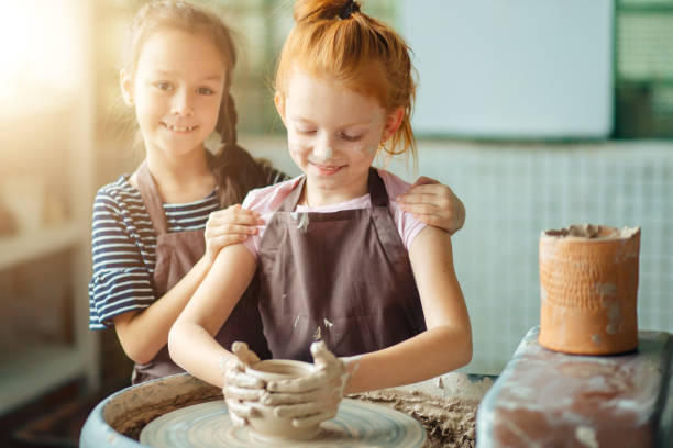 istock working process with clay potter wheel. Two girls making pottery in studio 1226171943
