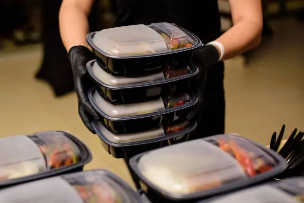 Lunch box with food in the hands. Catering.