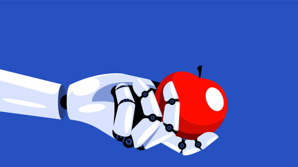 istock The robot is holding an apple. Mechanical hand is holding a red apple. Concept of machine learning, new technologies, cybernetics and robotics. AI learns and recognizes the world. 1226173316