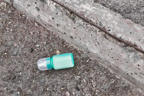 lost milk bottle for the baby lies on the side of the road