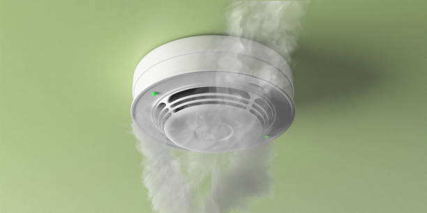 Fire detected by a smoke detector moulded on green ceiling.  Fire safety equipment. 3d illustration Fire smoke detected, smoke detector, fire alert device moulded on interior room ceiling. Domestic and business fire safety. 3d illustration fire alarm smoke detector smoke danger stock pictures, royalty-free photos & images