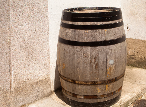Wine barrel used as sidewalk cafe table in a pedestrian zone, Betanzos, A Coruña province, Galicia, Spain. Copy space on the left side of the image.