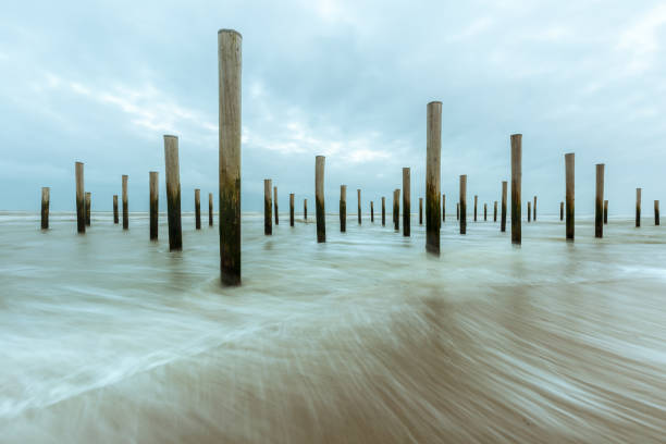 The Poles Village or Palendorp is a monument on the beach of Petten (Netherlands) in memory a historic flooding. Long exposure with sea waves.