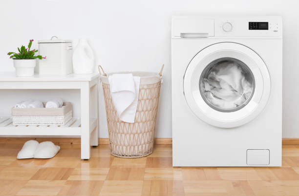 istock Laundry room interior with washing machine, basket and white shelves 1226179532