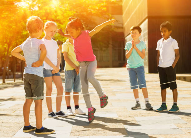 istock Happy children jumping game by rubber band and laughing 1226183329