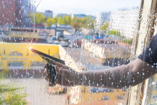 istock Rubber squeegee in male hand cleans a soaped window 1226186327