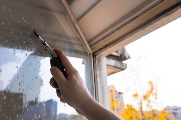 istock Rubber squeegee in male hand cleans a soaped window 1226186396
