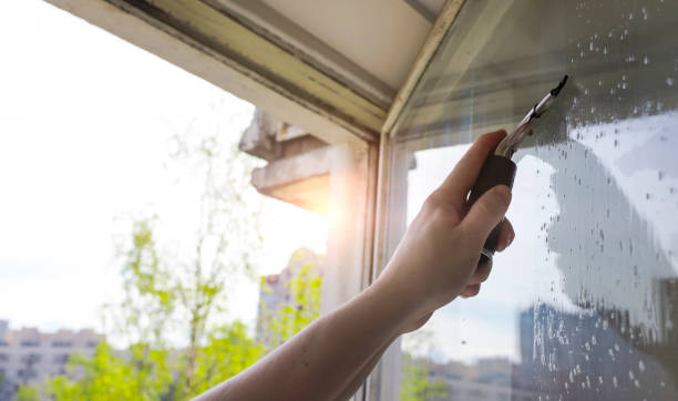 istock Rubber squeegee in male hand cleans a soaped window 1226186501