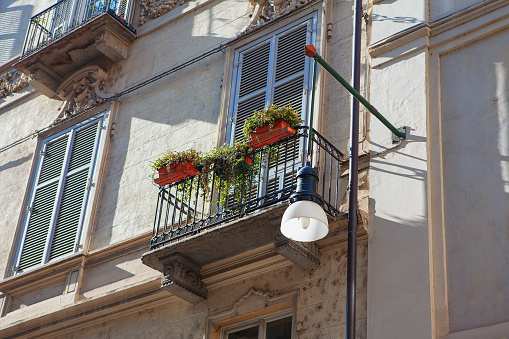 street lamp and balcony with flowerpots