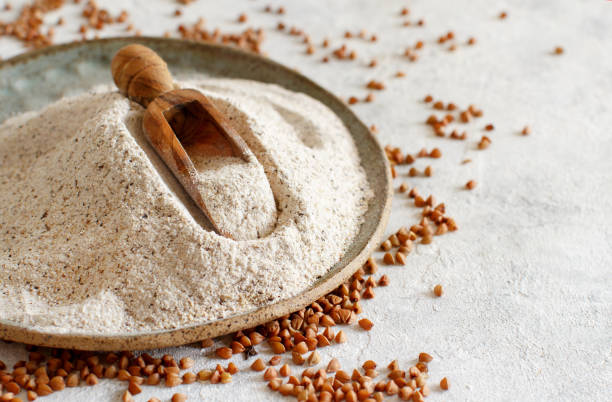 istock Buckwheat flour on a plate with a spoon and buckwheat grain 1226189038