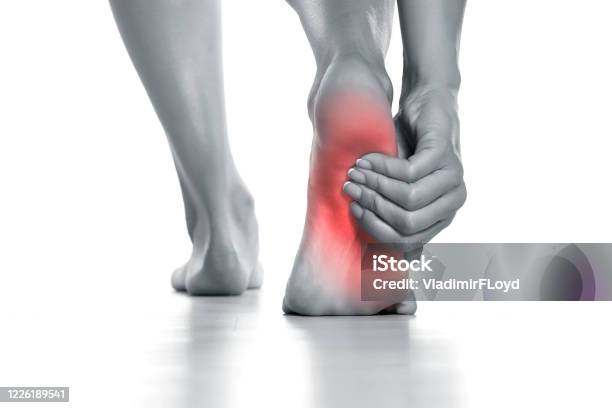 Woman Holding Her Painful Foot On White Stock Photo - Download Image Now - Pain, Foot, Human Foot
