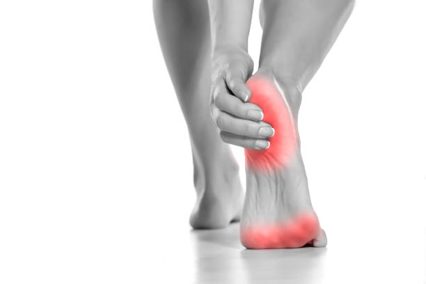 istock woman touching her painful heel on white background 1226189544