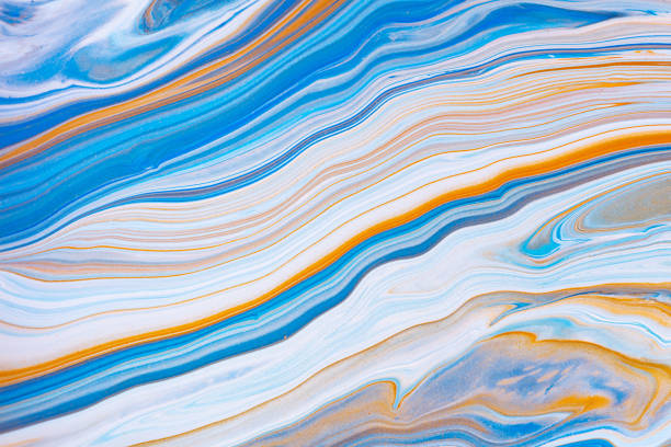 istock Fluid art texture. Background with abstract swirling paint effect. Liquid acrylic picture with flows and splashes. Mixed paints for baner or wallpaper. Blue, orange and white overflowing colors. 1226189637