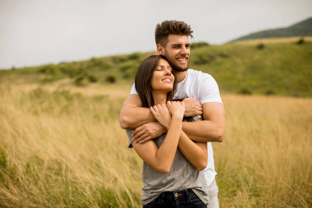 Young couple in love outside in spring nature