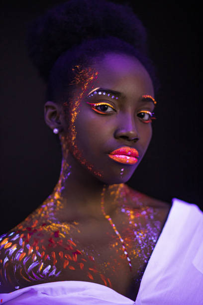 istock young female painted with UV makeup color 1226190490