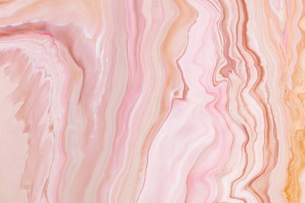 istock Fluid art texture. Abstract background with swirling paint effect. Liquid acrylic artwork that flows and splashes. Mixed paints for interior poster. Pink, golden and white overflowing colors. 1226190513