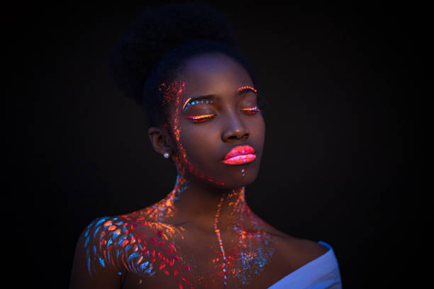 young female painted with UV makeup color