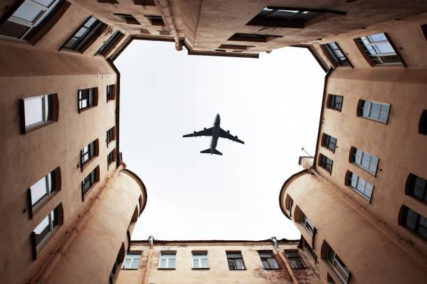 istock Airplane flying above the city view from courtyard 1226192886