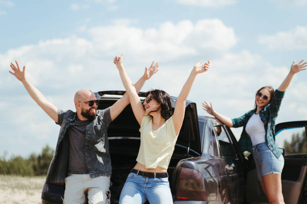 istock Three friends enjoying vacation travel by car 1226194234