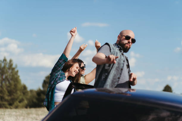 istock Three friends enjoying vacation travel by car 1226194267