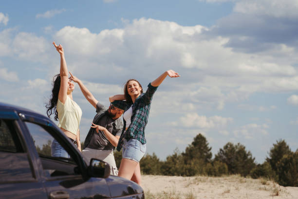 istock Three friends enjoying vacation travel by car 1226194297