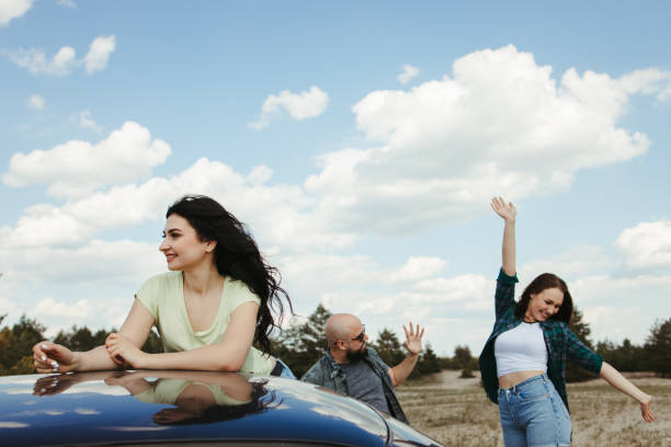 istock Three friends enjoying vacation travel by car 1226194353